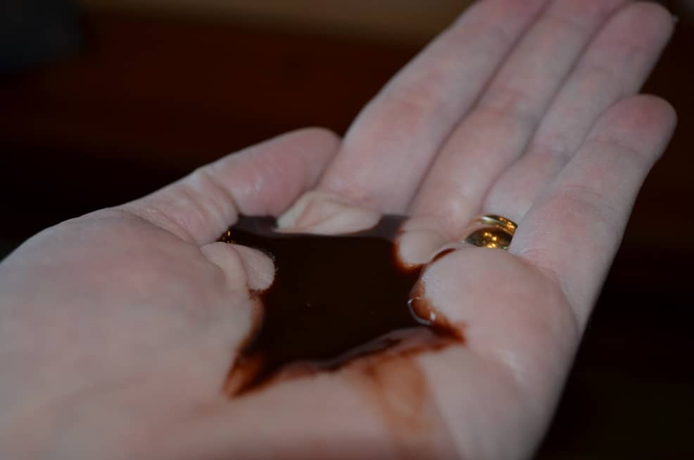 image close up of hand with chocolate sauce pooled in the middle