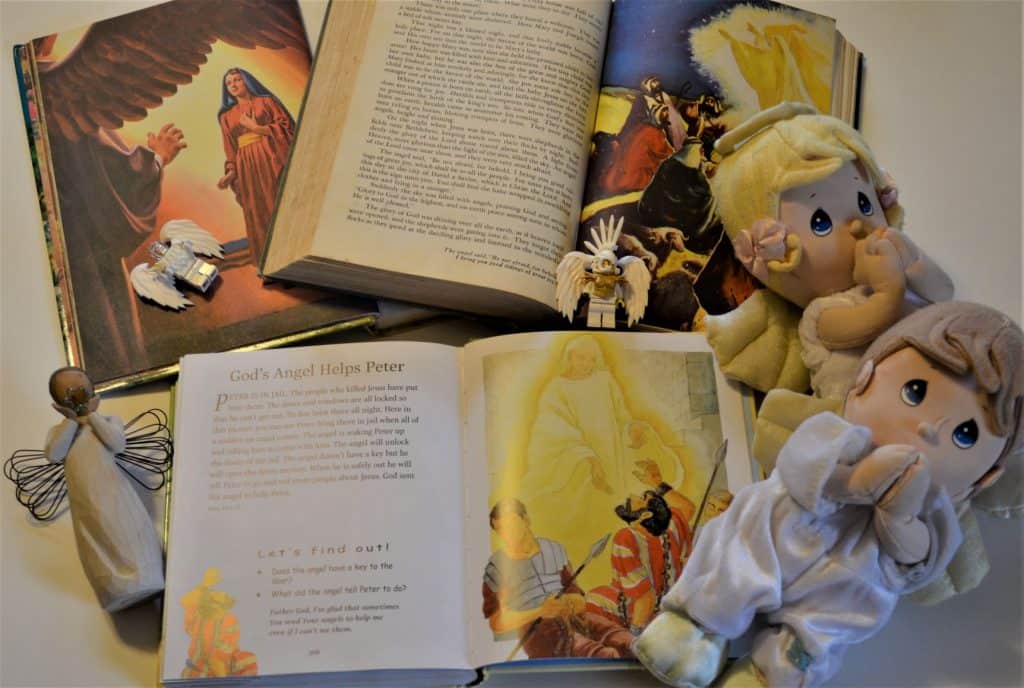 image of books with pictures of angels, 2 lego angels, 2 precious moments angels and 1 statue of an angel