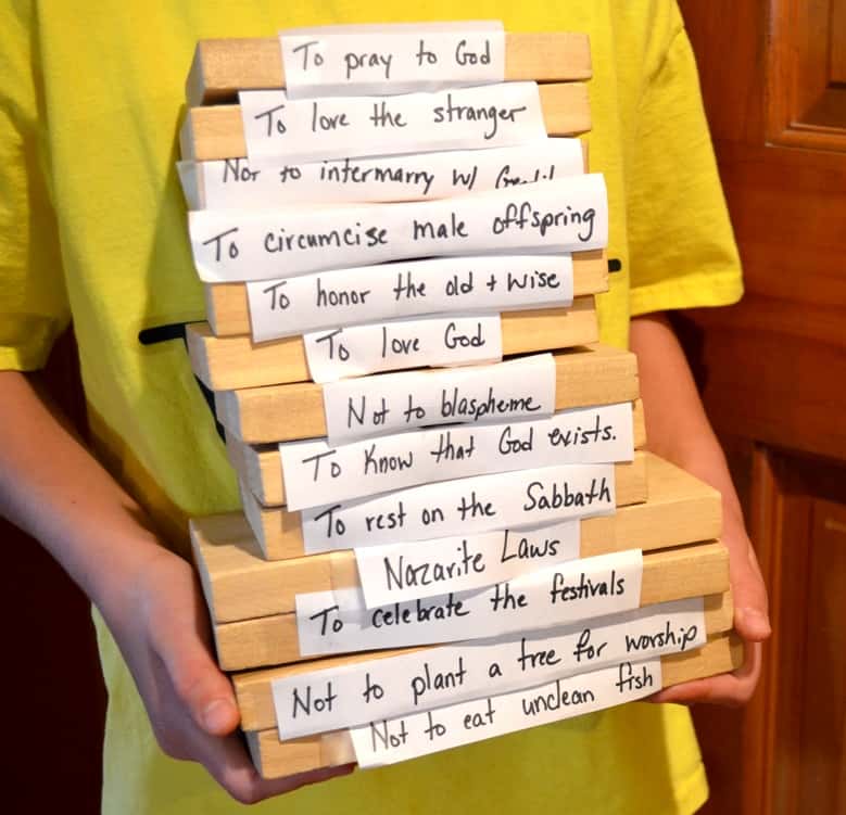 Child holding the 13 blocks in a stack